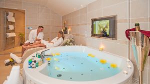 Couple in Bathrobes Beside Giant Luxury Hotel Spa Bath